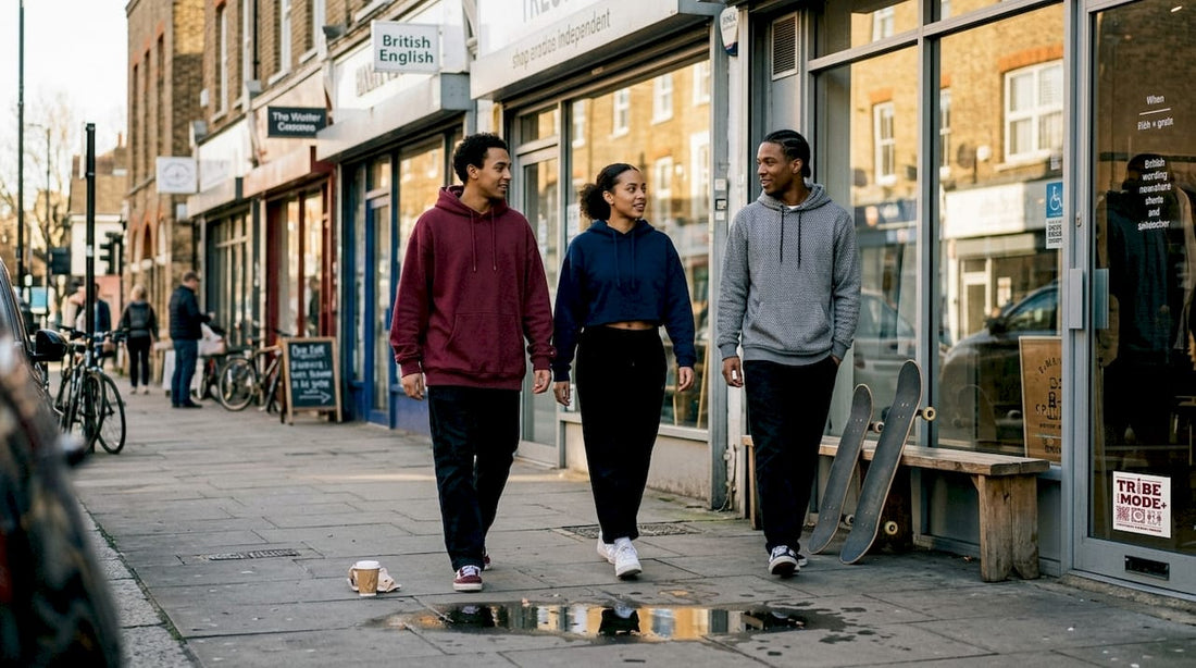 Young adults wearing hoodies on busy city street